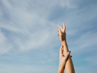 Person hands reaching for the sky during stretching session